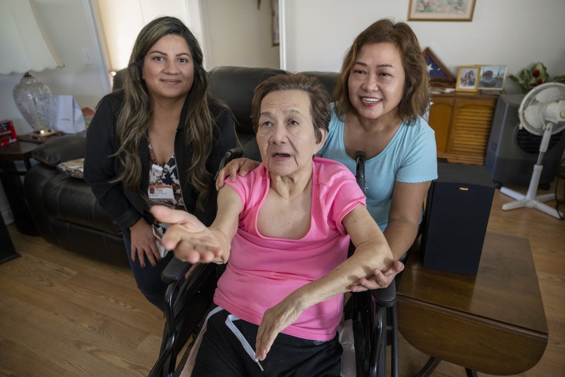 A caregiver, her parent, and her caregiver navigator in her mother's living room